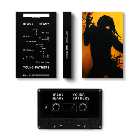 Muziekcassette van Young Fathers met de titel Heavy Heavy, zwart ontwerp, albumhoes zichtbaar in de afbeelding.
